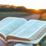 Open bible in hands close-up