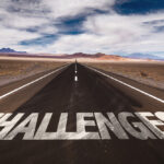 Word 'Challenges' written on desert road
