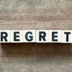 Word 'Regret' on wooden cubes