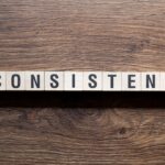 Word 'Consistent' written on wooden blocks