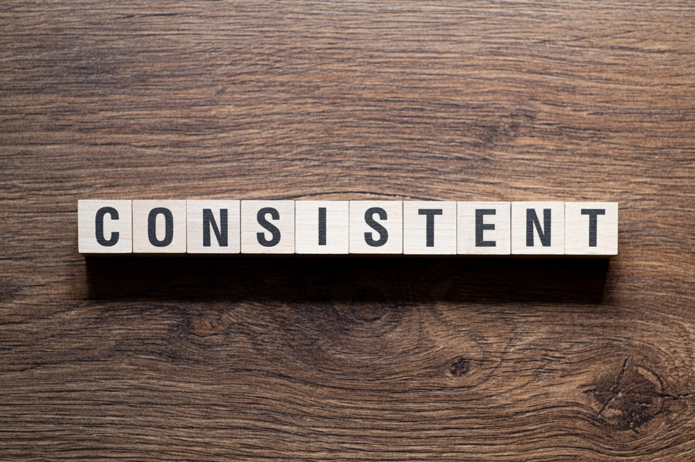 Word 'Consistent' written on wooden blocks